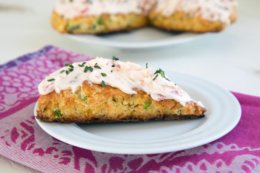 Eat Your Vegetables Savory Scones -- These Savory Scones can be made with any vegetables or cheese you need to use up in your fridge. This version uses carrots, kale, bell peppers, and feta with a savory tomato cream cheese icing as the perfect topping | wearenotmartha.com