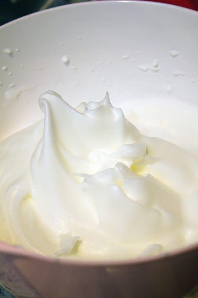 Bowl with egg whites that have been beaten into stiff peaks