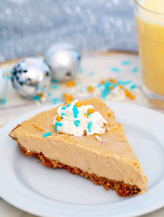 Eggnog Ice Cream Pie -- This Eggnog Ice Cream Pie is made with homemade ice cream, a gingersnap crust, and rum whipped cream. It's a simple dessert that's perfect for the holidays