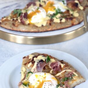 Eggs Benedict Pizza -- What could be better than combining two of the best foods on Earth into an Eggs Benedict Pizza? Packed with prosciutto, hollandaise sauce, and perfectly cooked eggs, you'll fall in love with this brunch pizza | wearenotmartha.com
