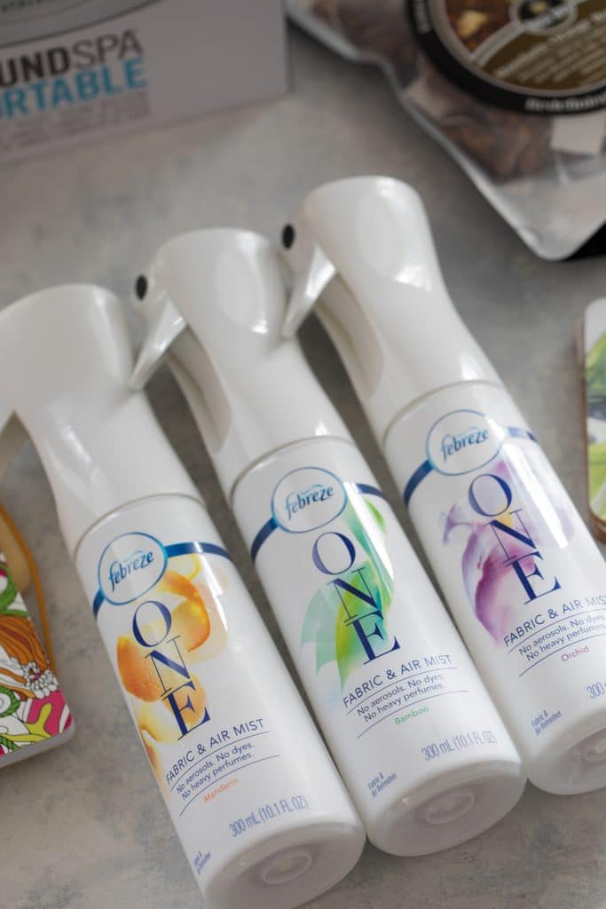 Row of Febreze ONE Fabric & Air Mist products with Mandarin, Bamboo, and Orchid fragrances