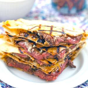 Head-on view of flank steak quesadillas with gorgonzola stacked on each other