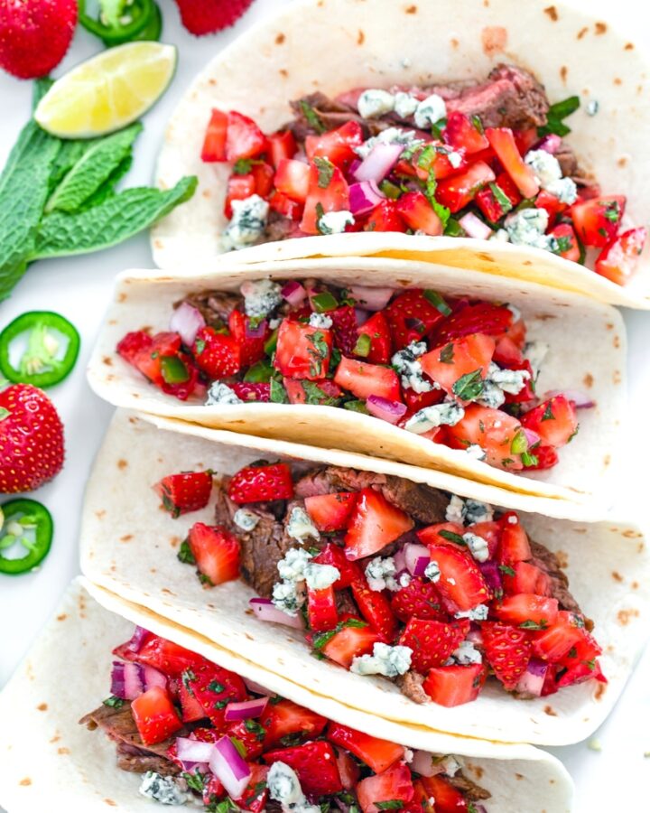 Flank Steak Tacos with Strawberry Mint Salsa -- These Flank Steak Tacos are a flavor explosion thanks to strawberry mint salsa and gorgonzola cheese... They'll help you hold on to summer for as long as possible! | wearenotmartha.com