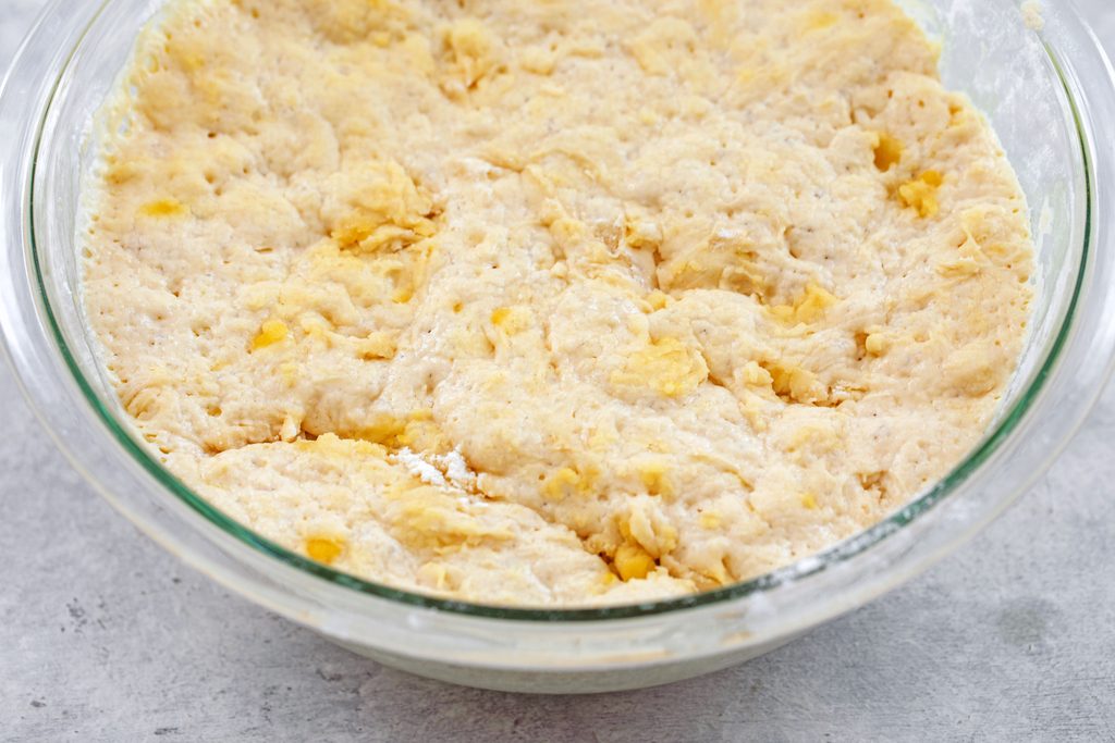 Overhead view of flatbread dough rising in bowl