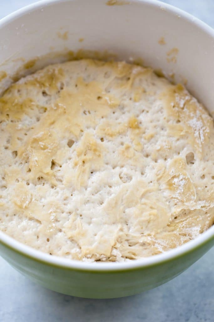 A large bowl showing flatbread dough that has risen