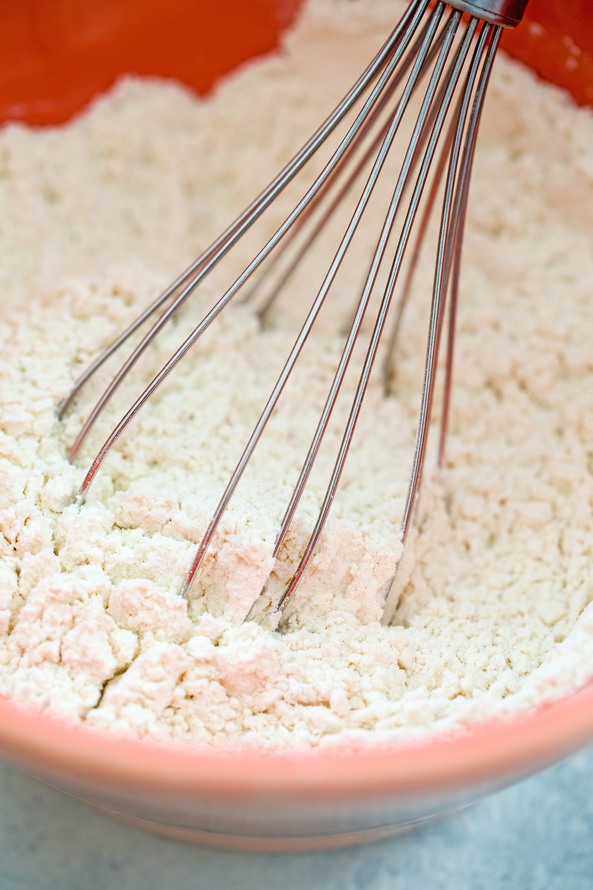 Flour mixture being whisked together in bowl.