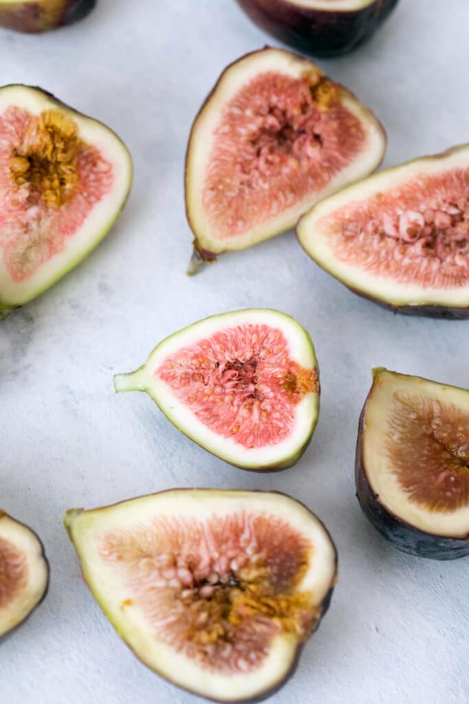 Overhead view of several fresh figs sliced in half