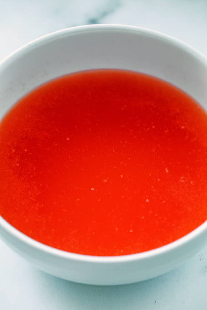 Overhead view of freshly squeezed grapefruit juice in a bowl