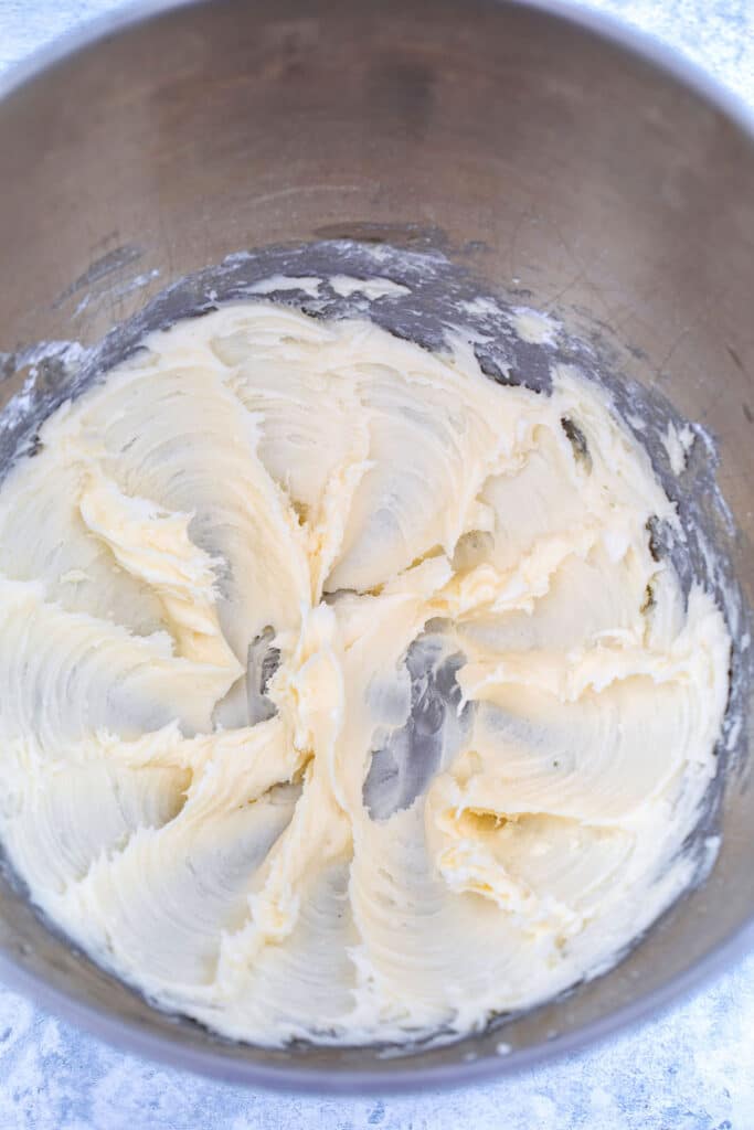 Overhead view of buttercream frosting in mixing bowl