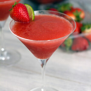 Frozen Strawberry Cosmo -- Remember the cosmo? It's back! But this time the cranberry and lime are combined with frozen strawberries for an icy frozen strawberry cosmopolitan treat | wearenotmartha.com