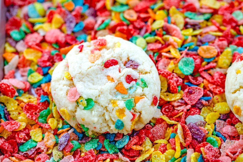 Landscape overhead image of a Fruity Pebbles cookie on a bed of cereal