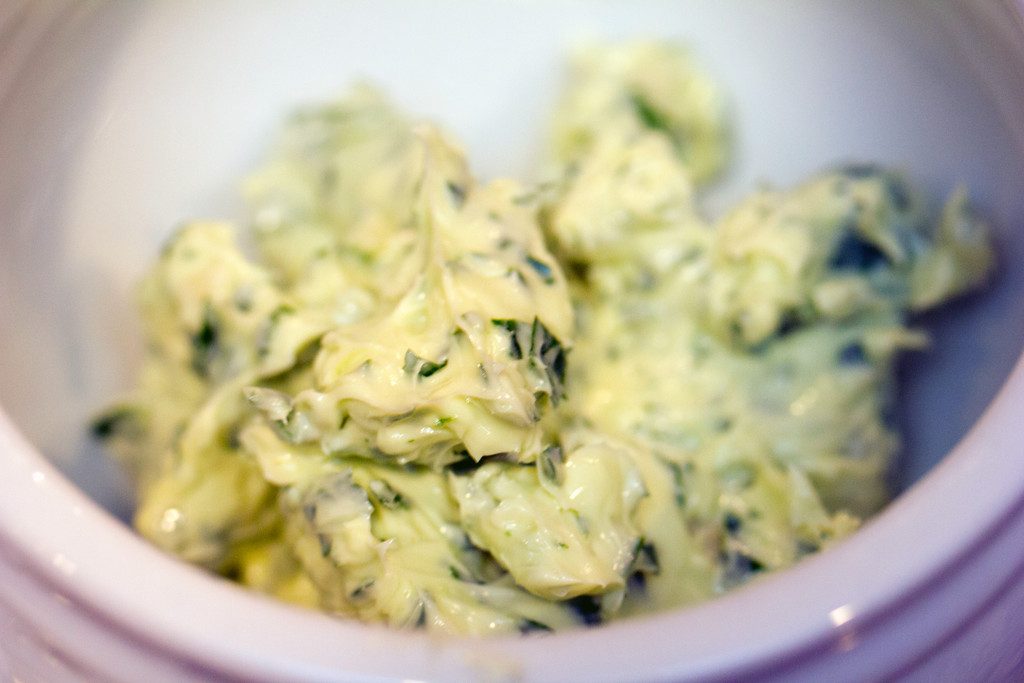 Overhead view of butter with parsley and garlic mixed in