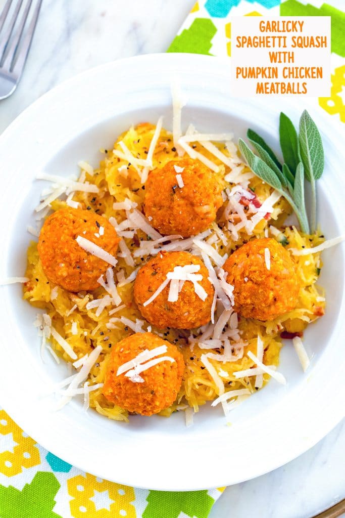 Overhead view of garlicky spaghetti squash in a white bowl with chicken pumpkin meatballs and parmesan cheese on top with sage and recipe title at the top