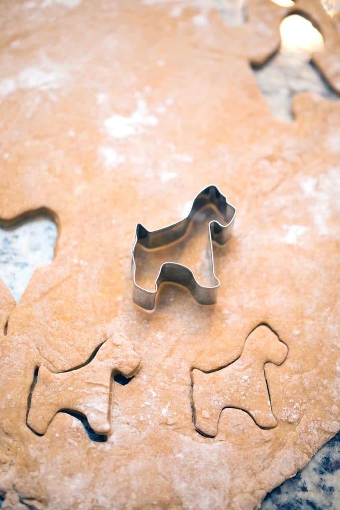 Cutting dog shapes out of cookie dough