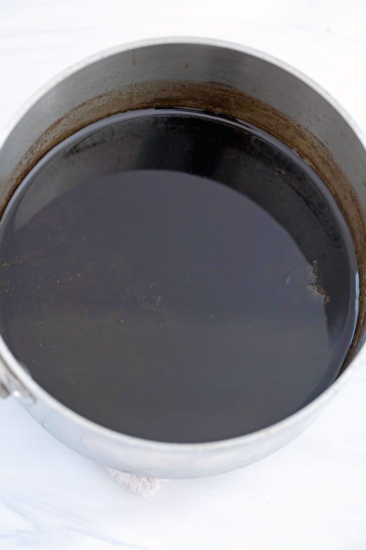 Overhead view of gingerbread syrup in a saucepan.