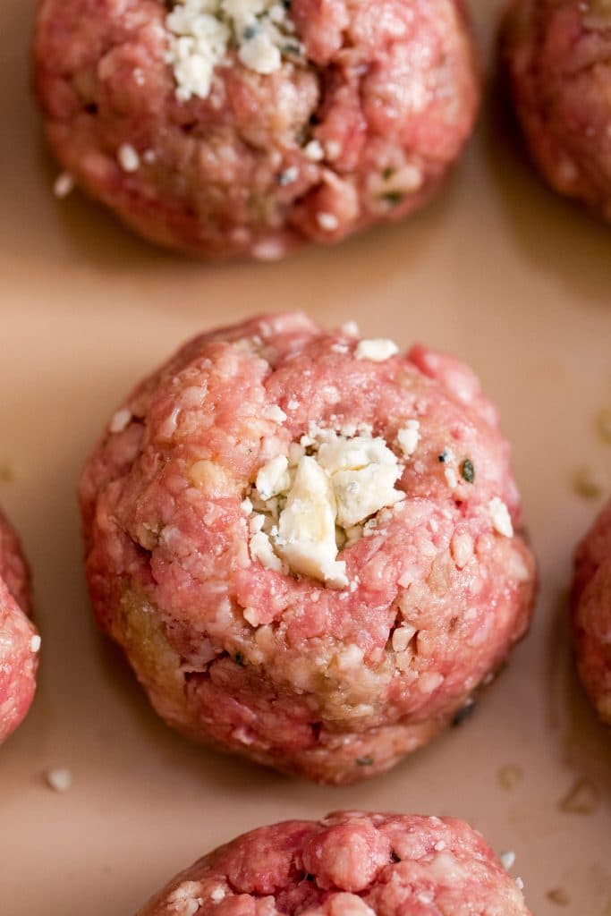 Overhead view of meatballs stuffed with gorgonzola ready to be baked