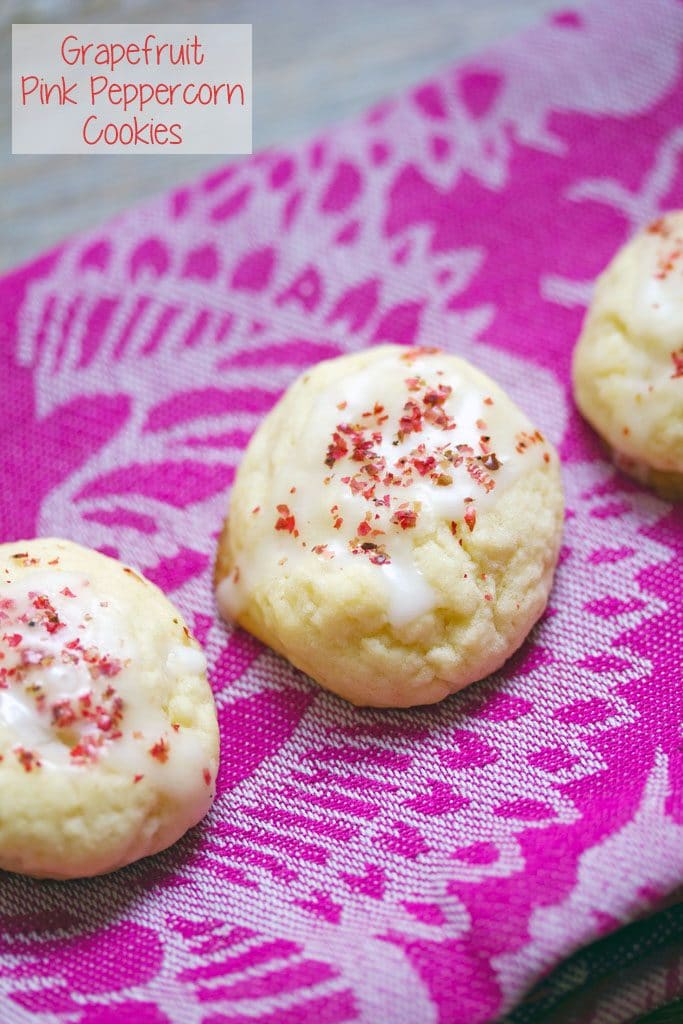 Three grapefruit pink peppercorn cookies on a pink towel with "Grapefruit Pink Peppercorn Cookies" text at top