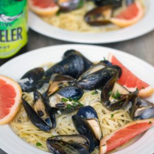 Grapefruit Shandy Mussels with Grapefruit Linguine -- Grapefruit Shandy Mussels with Grapefruit Linguine is the "eat on the deck" summer meal you've been waiting for. Mussels and pasta packed with a citrus punch! | wearenotmartha.com