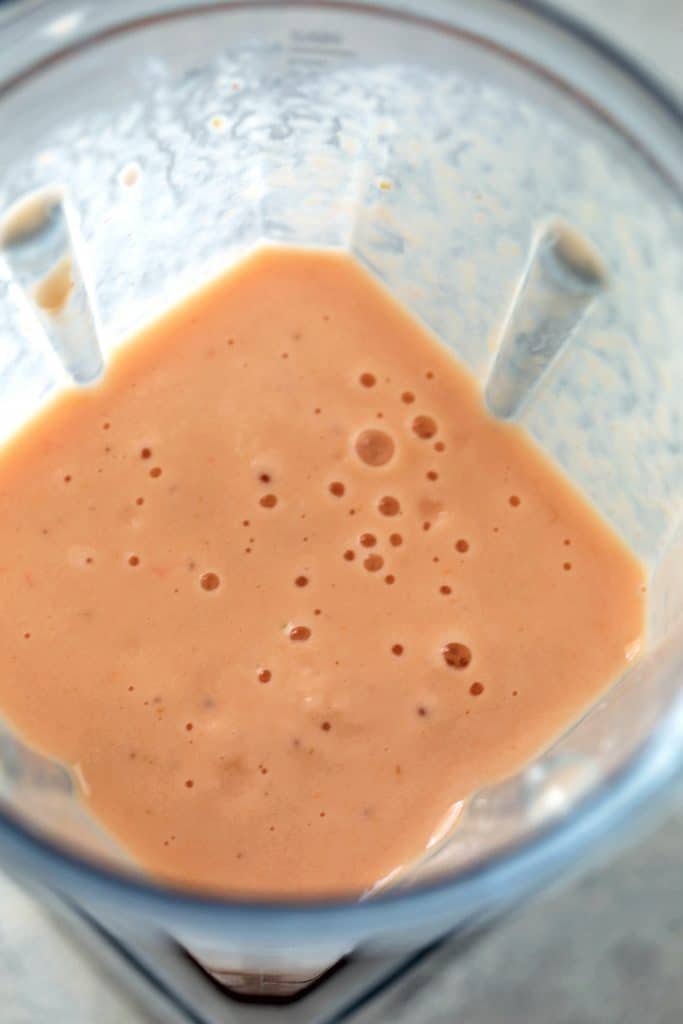 Blender with grapefruit, pineapple, banana, and Greek yogurt blended together