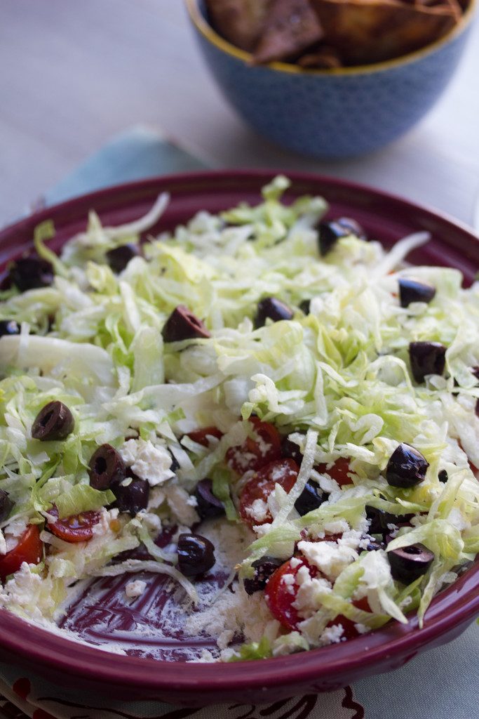 Greek Taco Dip with Black Peppercorn Pita Chips -- The perfect alternative to a party taco dip | wearenotmartha.com