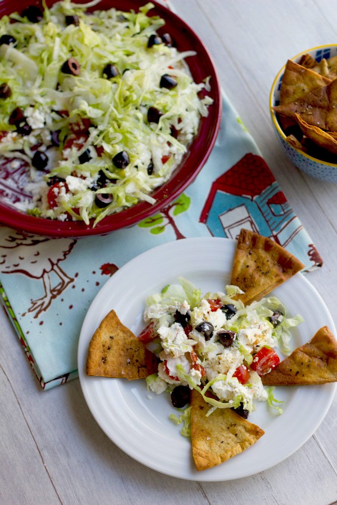 Greek Taco Dip with Black Peppercorn Pita Chips -- The perfect alternative to a party taco dip | wearenotmartha.com