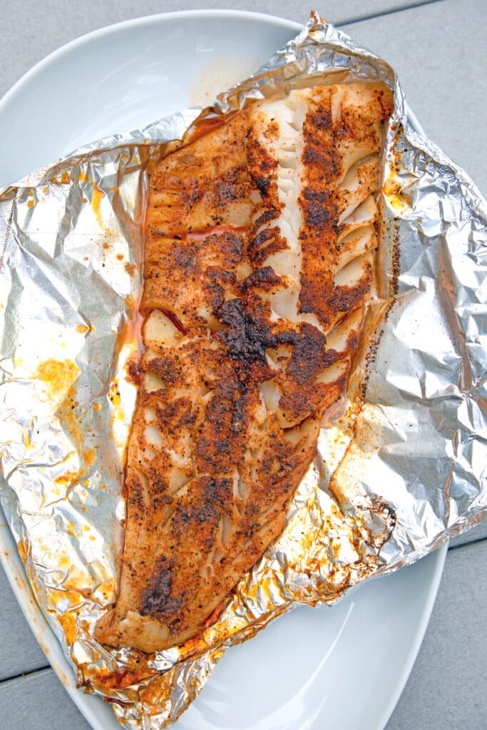 Overhead view of cod just off the grill on foil