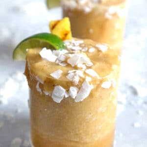 Grilled Pineapple Coconut Margaritas -- Pineapple is delicious on all on its own, but grilling it brings out a whole new depth of flavor. This Grilled Pineapple Coconut Margarita is easy to make and perfect as a tropical cocktail! | wearenotmartha.com