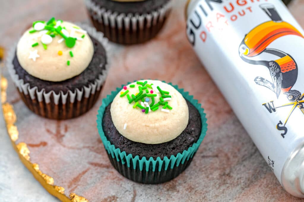 Landscape overhead view of multiple Guinness cupcakes with can of Guinness next to them
