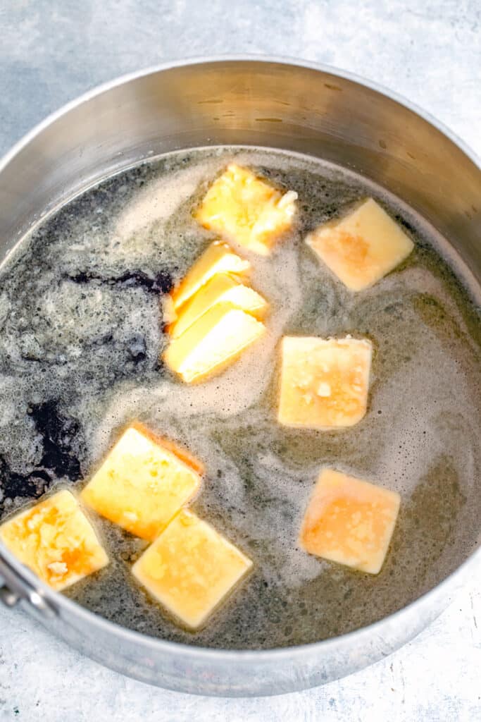 Guinness and cubed butter in saucepan.