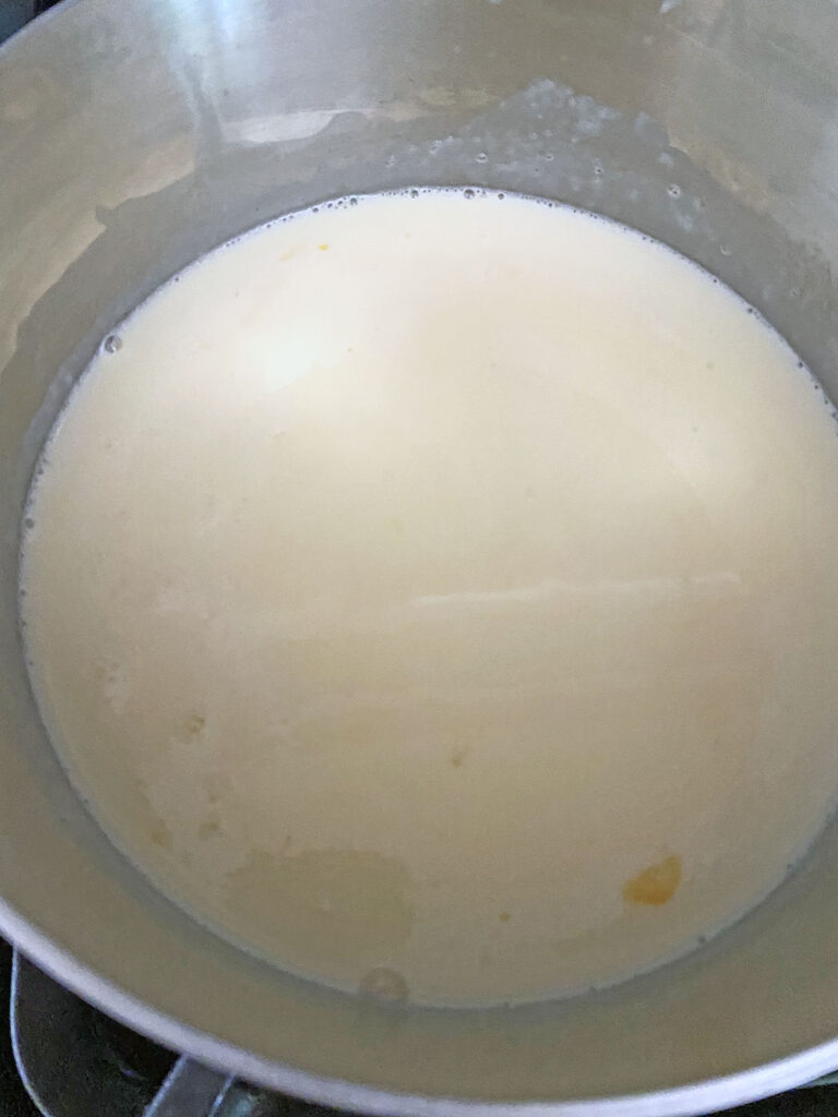 Ice cream custard base cooking in saucepan