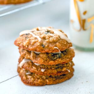 Oatmeal Applesauce Cookies -- These Iced Oatmeal Applesauce Cookies are packed with oats, applesauce, and two types of raisins, for the most delightfully chewy oatmeal cookie around! Drizzle them with a maple icing and just try not to eat the whole batch in one sitting | wearenotmartha.com