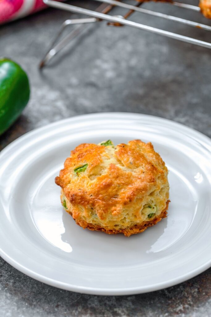 Close-up of a jalapeño cheddar scone on a white plate