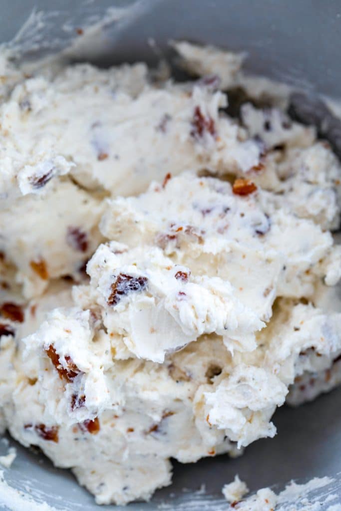 Overhead view of cream cheese and bacon mixture in a bowl for bacon white pizza dip