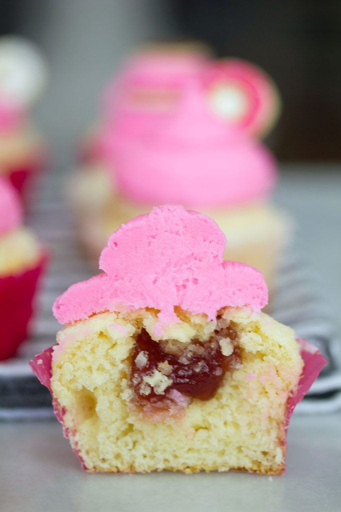 Head-on view of half a jelly doughnut cupcake to show jelly filling
