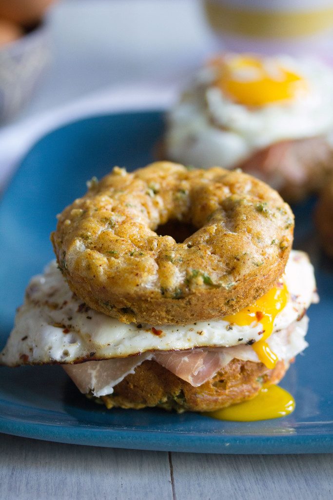 Kale Cheddar Doughnut Egg Sandwiches -- Eggs and prosciutto sandwiched between two savory doughnuts | wearenotmartha.com 