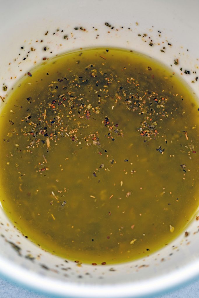 Overhead view of Greek salad dressing mixed together in bowl