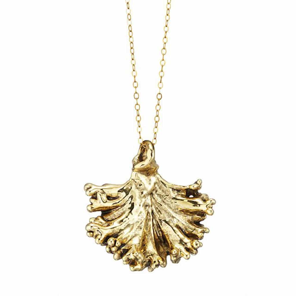 Head on view of gold kale necklace on a gold chain