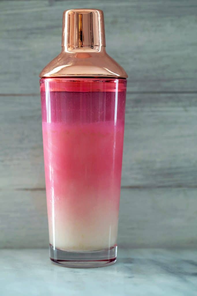 Pink and rose gold Oh Joy! for Target cocktail shaker filled with cocktail mixture