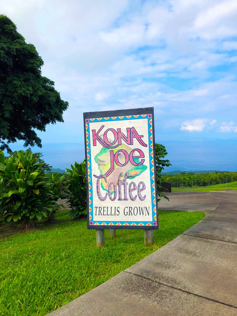 Entrance to Kona Joe's in Kona on the Big Island of Hawaii with a sign and blue sky background