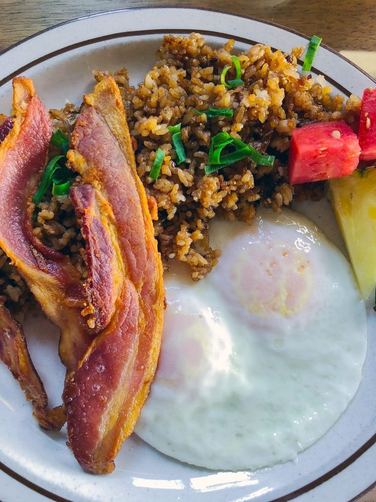 Eggs, bacon, rice, and fruit at Kula Sandalwoods in Maui