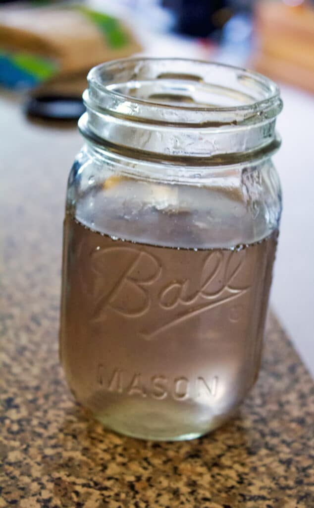 Mason jar filled with light purple lavender simple syrup