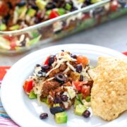 Layered Taco Salad -- Think layered taco salads are just for parties? Think again! This salad features layers of lettuce, beef, tomatoes, avocados, black beans, cheese, and olives and makes for the most delicious dinner | wearenotmartha.com