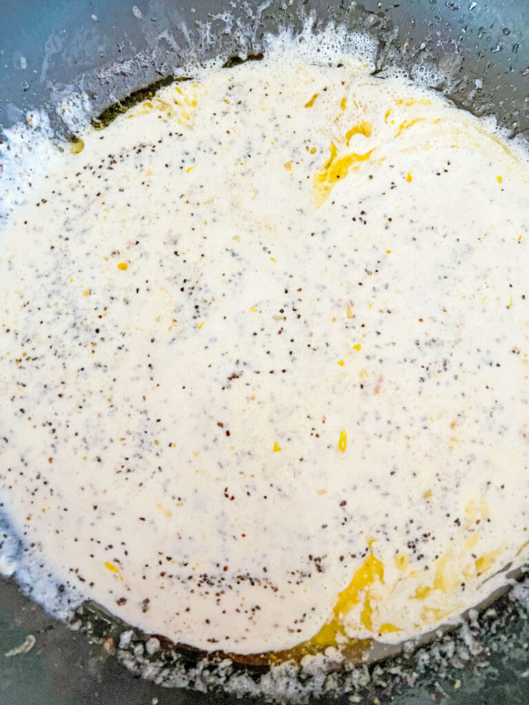 Creamy lemon pepper sauce in skillet.