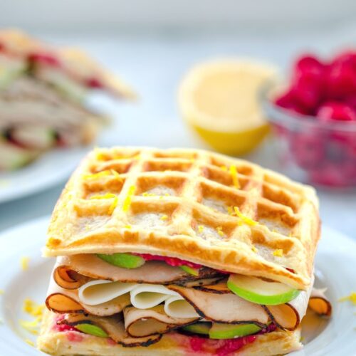 These Lemon Waffle Sandwiches are loaded with honey turkey, provolone cheese, and green apples, with a simple raspberry spread. They're perfect for enjoying during a late summer's picnic or any time of year!