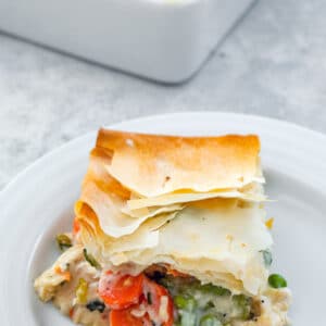 Lighter Chicken Pot Pie -- This Lighter Chicken Pot Pie is packed with all the good stuff and topped with a buttery phyllo dough crust. A little bit healthier than the original, but just as tasty! | wearenotmartha.com