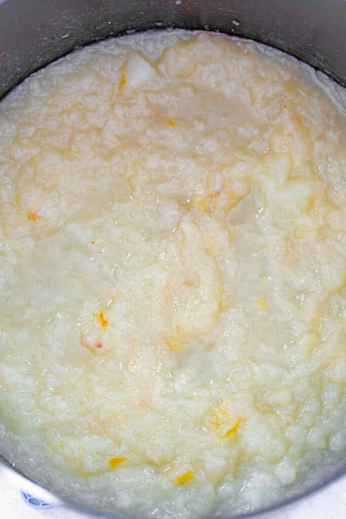 Overhead view of chunky pear sauce mashed in a large saucepan.