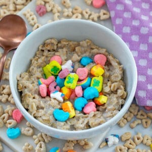 Closeup view of Lucky Charms oatmeal in bowl with marshmallows on top.