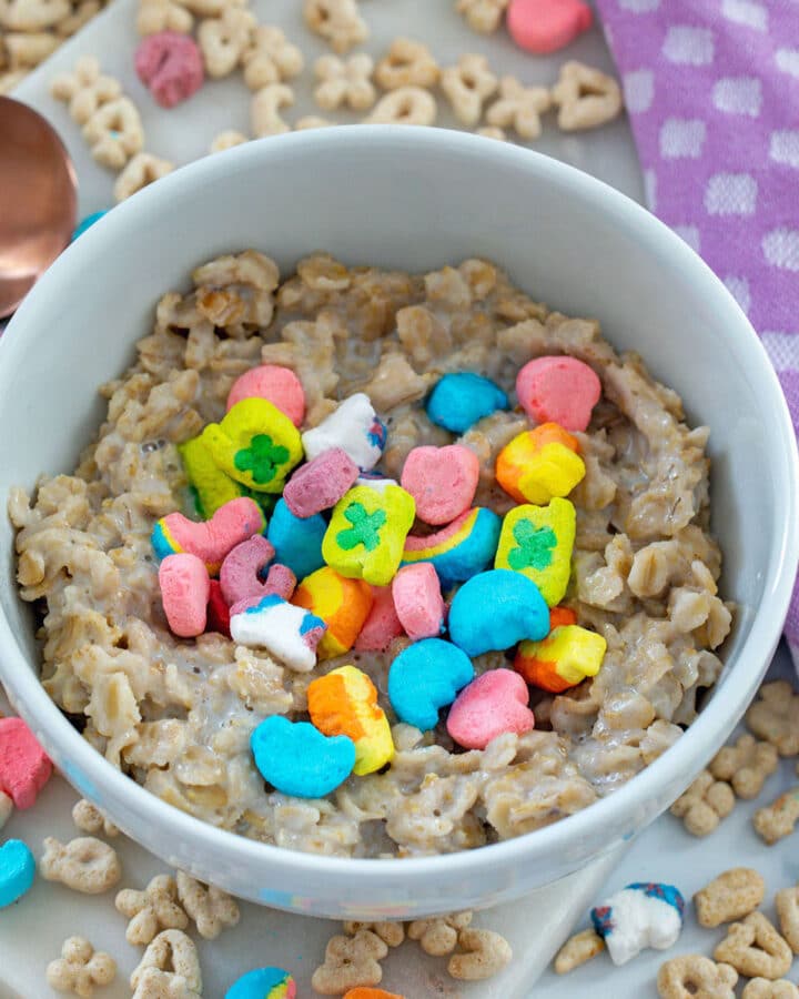 Closeup view of Lucky Charms oatmeal in bowl with marshmallows on top.