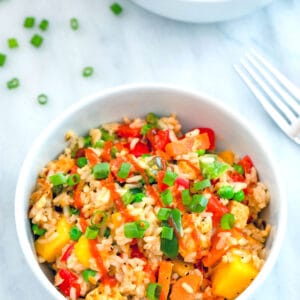 Mango Coconut Fried Rice -- This Mango Coconut Fried Rice is made with coconut brown rice and packed with colorful veggies and mango Sriracha marinated tofu | wearenotmartha.com