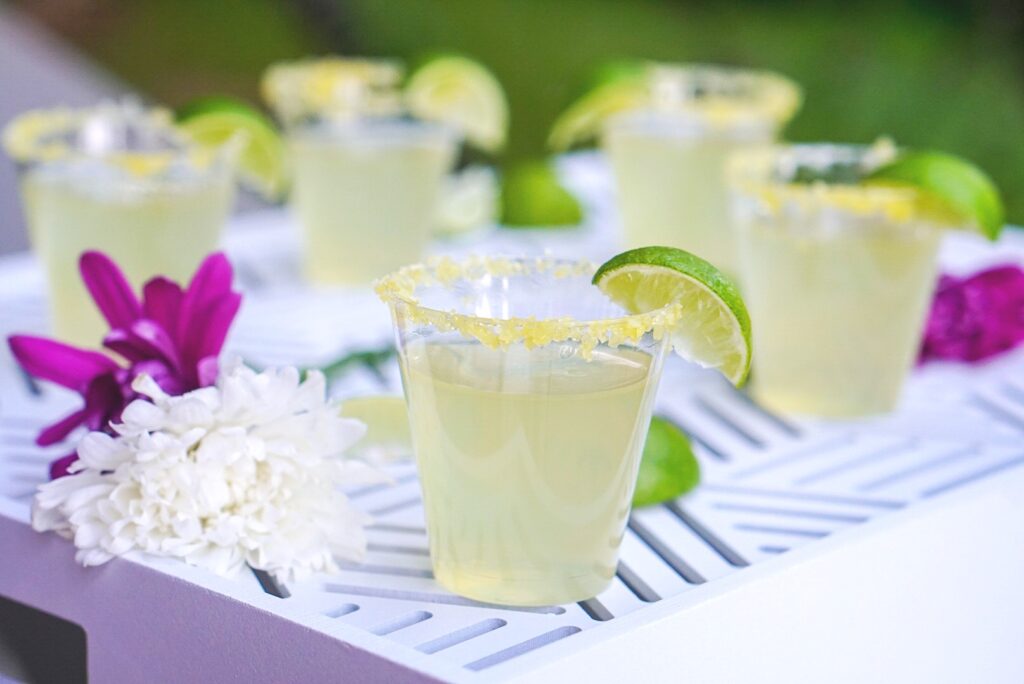 Margarita jello shots in little cups with salted rims and lime wedge garnish